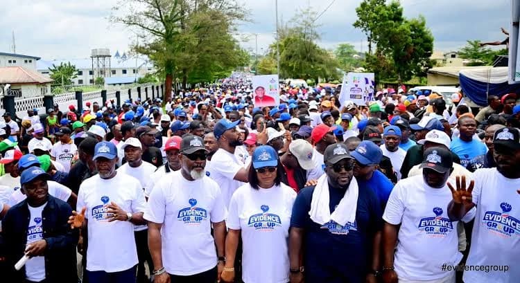 Crowd of supporters marching with a banner overhead